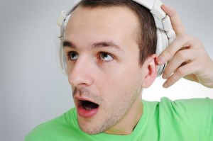 man listening to dental news